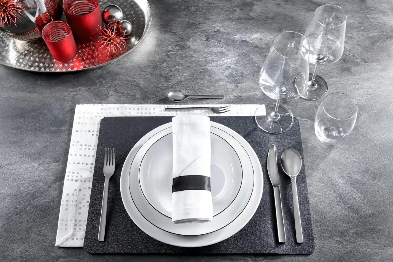 Ein Wasserglas steht rechts neben den Weingl&auml;sern. Der Tisch ist f&uuml;r ein festliches Essen gedeckt.
